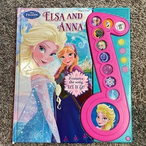 Elsa and Anna play a song hardcover book Disney